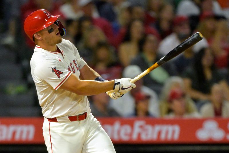 Apr 5, 2025; Anaheim, California, USA;  Los Angeles Angels center fielder Mike Trout (27) hits a two-run home run in the fifth inning against the Cleveland Guardians at Angel Stadium. Mandatory Credit: Jayne Kamin-Oncea-Imagn Images