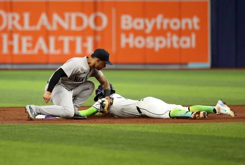 May 10, 2024; St. Petersburg, Florida, USA; New York Yankees second base Gleyber Torres (25) attempts to tag out Tampa Bay Rays shortstop José Caballero (7) as he slides safe into second base during the third inning at Tropicana Field. Mandatory Credit: Kim Klement Neitzel-USA TODAY Sports