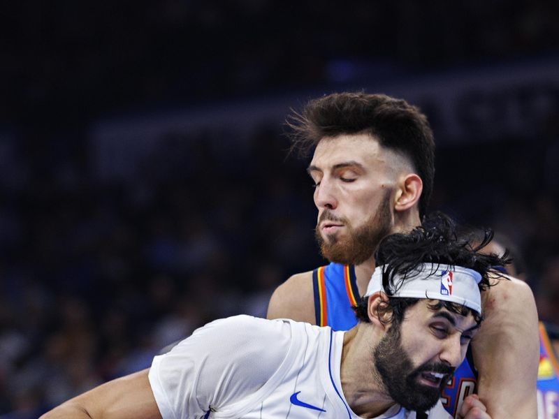 OKLAHOMA CITY, OKLAHOMA - NOVEMBER 4: Goga Bitadze #35 of the Orlando Magic goes to the basket in the second half against Chet Holmgren #7 of the Oklahoma City Thunder at Paycom Center on November 4, 2024 in Oklahoma City, Oklahoma. NOTE TO USER: User expressly acknowledges and agrees that, by downloading and or using this Photograph, user is consenting to the terms and conditions of the Getty Images License Agreement. The Thunder defeated the Magic 102-86.  (Photo by Wesley Hitt/Getty Images)