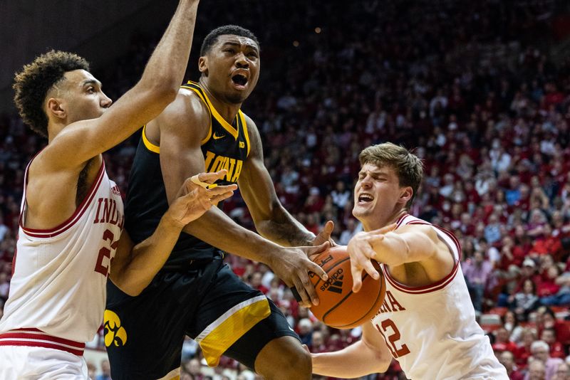 Feb 28, 2023; Bloomington, Indiana, USA; Iowa Hawkeyes guard Tony Perkins (11) shoots the ball while Indiana Hoosiers forward Miller Kopp (12) defends in the second half at Simon Skjodt Assembly Hall. Mandatory Credit: Trevor Ruszkowski-USA TODAY Sports