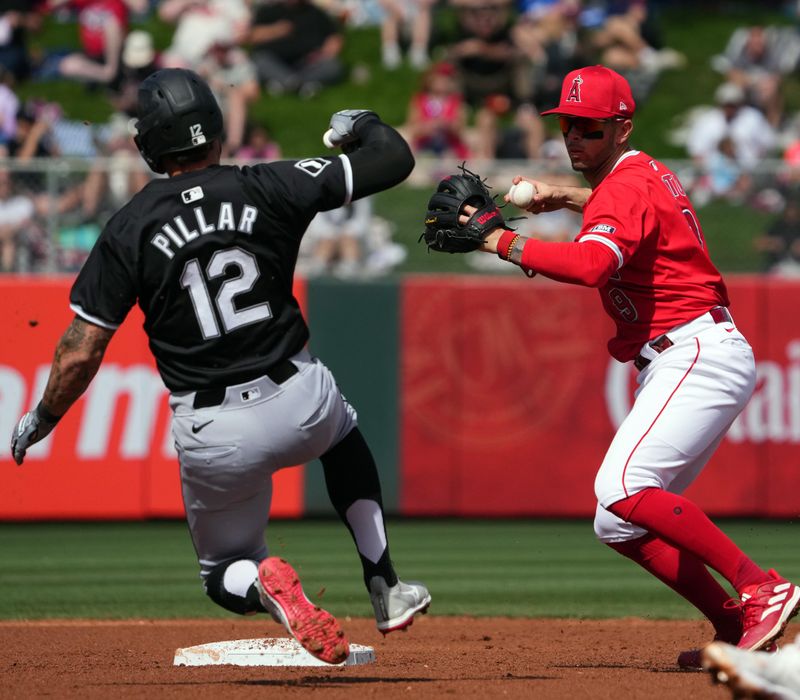 Mar 3, 2024; Tempe, Arizona, USA; Los Angeles Angels shortstop Zach Neto (9) throws to first to complete a double play after forcing out Chicago White Sox outfielder Kevin Pillar (12) at second base during the second inning at Tempe Diablo Stadium. Mandatory Credit: Joe Camporeale-USA TODAY Sports