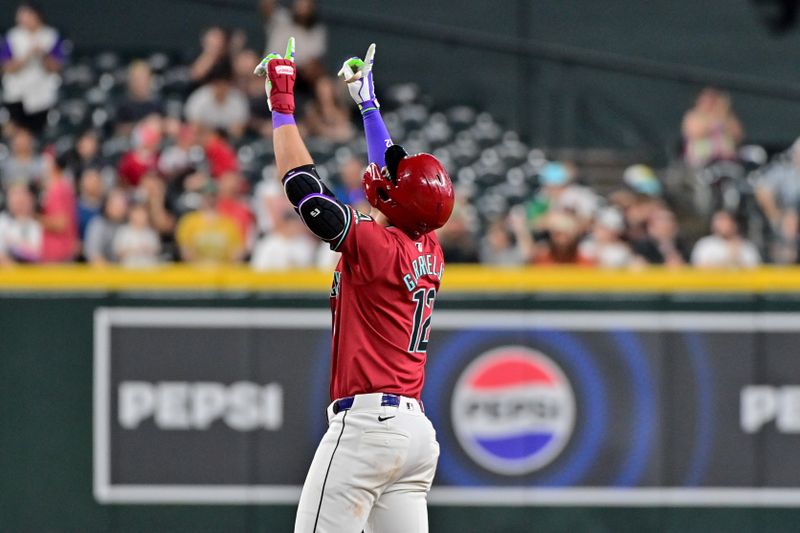 May 15, 2024; Phoenix, Arizona, USA;  Arizona Diamondbacks outfielder Lourdes Gurriel Jr. (12) celebrates an RBI double in the eighth inning against the Cincinnati Reds at Chase Field. Mandatory Credit: Matt Kartozian-USA TODAY Sports