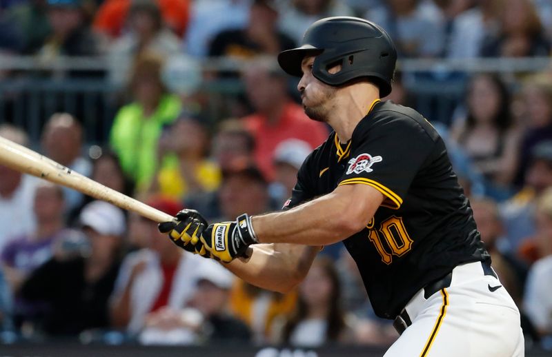 Aug 22, 2024; Pittsburgh, Pennsylvania, USA;  Pittsburgh Pirates left fielder Bryan Reynolds (10) hits a RBI single against the Cincinnati Reds during the fifth inning at PNC Park. Mandatory Credit: Charles LeClaire-USA TODAY Sports