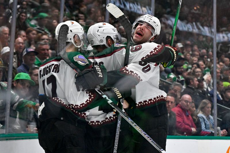 Nov 14, 2023; Dallas, Texas, USA; Arizona Coyotes left wing Lawson Crouse (67) and left wing Matias Maccelli (63) and center Nick Bjugstad (17) and defenseman Sean Durzi (50) celebrates after Crouse scores a goal against Dallas Stars goaltender Jake Oettinger (29) during the third period at the American Airlines Center. Mandatory Credit: Jerome Miron-USA TODAY Sports