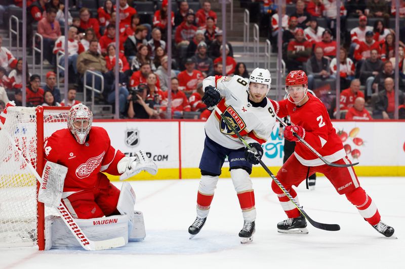 Mar 2, 2024; Detroit, Michigan, USA; Florida Panthers center Sam Bennett (9) and Detroit Red Wings defenseman Olli Maatta (2) fight for position in front of Detroit Red Wings goaltender Alex Lyon (34) in the third period at Little Caesars Arena. Mandatory Credit: Rick Osentoski-USA TODAY Sports