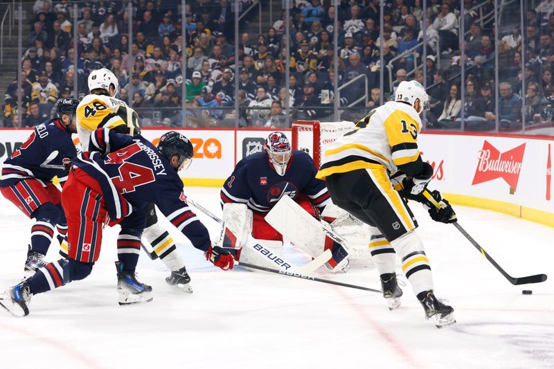 Oct 20, 2024; Winnipeg, Manitoba, CAN; Winnipeg Jets defenseman Josh Morrissey (44) checks Pittsburgh Penguins right wing Kevin Hayes (13) in front of Winnipeg Jets goaltender Eric Comrie (1) in the first period at Canada Life Centre. Mandatory Credit: James Carey Lauder-Imagn Images