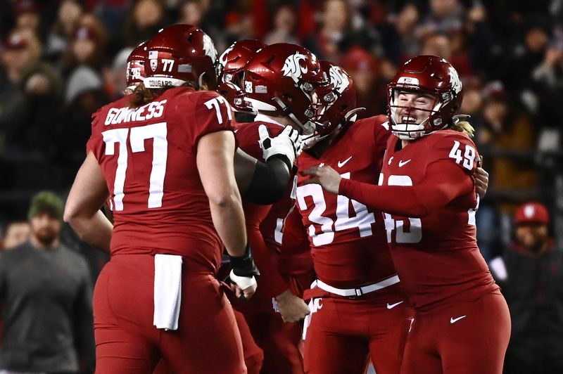 Nov 26, 2022; Pullman, Washington, USA; Washington State Cougars place kicker Dean Janikowski (49) celebrates after licking a field goal against the Washington Huskies first half at Gesa Field at Martin Stadium. Mandatory Credit: James Snook-USA TODAY Sports