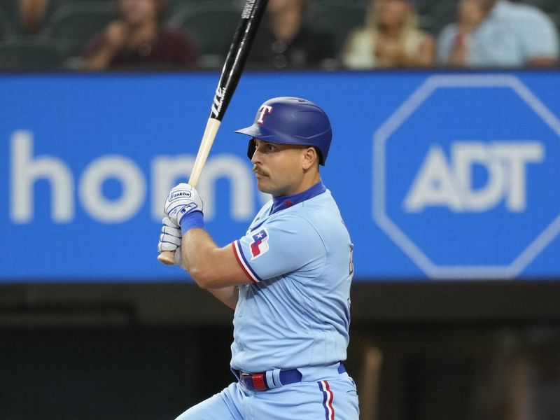 Jul 16, 2023; Arlington, Texas, USA; Texas Rangers first baseman Nathaniel Lowe (30) follows through on his RBI single against the Cleveland Guardians during the eighth inning at Globe Life Field. Mandatory Credit: Jim Cowsert-USA TODAY Sports