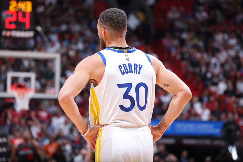 MIAMI, FL - MARCH 26:  Stephen Curry #30 of the Golden State Warriors looks on during the game against the Miami Heat on March 26, 2024 at Kaseya Center in Miami, Florida. NOTE TO USER: User expressly acknowledges and agrees that, by downloading and or using this Photograph, user is consenting to the terms and conditions of the Getty Images License Agreement. Mandatory Copyright Notice: Copyright 2024 NBAE (Photo by Jeff Haynes/NBAE via Getty Images)