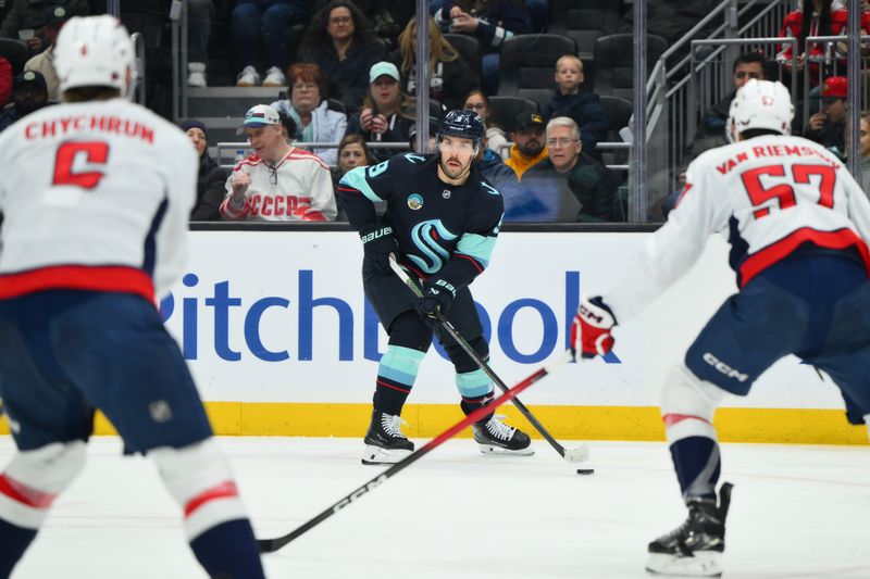 Jan 27, 2026; Seattle, Washington, USA; Seattle Kraken center Chandler Stephenson (9) plays the puck during the second period against the Washington Capitals at Climate Pledge Arena. Mandatory Credit: Steven Bisig-Imagn Images