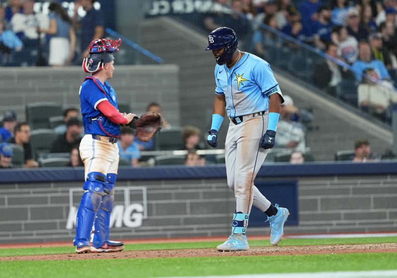 May 13, 2025; Toronto, Ontario, CAN; Tampa Bay Rays third baseman Junior Caminero (13) celebrates hitting a grand slam home run against the Toronto Blue Jays during the ninth inning at Rogers Centre. Mandatory Credit: Nick Turchiaro-Imagn Images