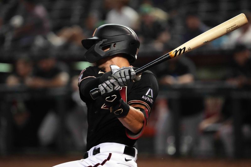 May 9, 2023; Phoenix, Arizona, USA; Arizona Diamondbacks shortstop Nick Ahmed (13) hits an RBI single against the Miami Marlins during the fourth inning at Chase Field. Mandatory Credit: Joe Camporeale-USA TODAY Sports