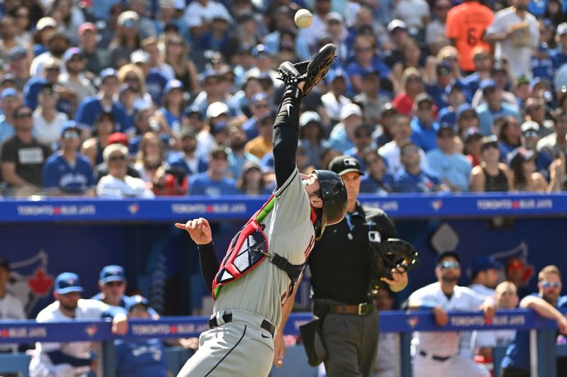 Aug 27, 2023; Toronto, Ontario, CAN;  Cleveland Guardians catcher Eric Haase (9) catches a pop foul hit by Toronto Blue Jays third baseman Matt Chapman (not shown) in the fourth inning at Rogers Centre. Mandatory Credit: Dan Hamilton-USA TODAY Sports