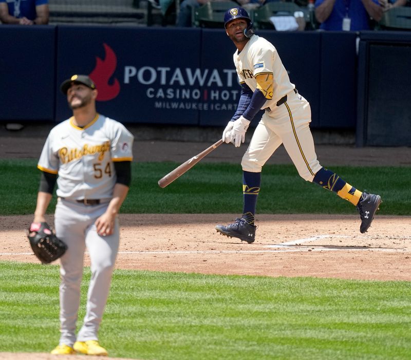 May 15, 2024; Milwaukee, Wisconsin, USA; Milwaukee Brewers outfielder Jackson Chourio (11) hits a two-run home run off off Pittsburgh Pirates pitcher Martín Pérez (54) during the sixth inning of their game at American Family Field . Mandatory Credit: Mark Hoffman-USA TODAY Sports