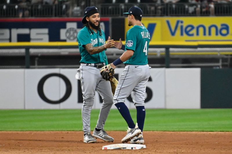 Aug 22, 2023; Chicago, Illinois, USA; Seattle Mariners shortstop J.P. Crawford (3), left, and Seattle Mariners third baseman Josh Rojas (4) celebrate after the team   s game against the Chicago White Sox at Guaranteed Rate Field. Mandatory Credit: Matt Marton-USA TODAY Sports