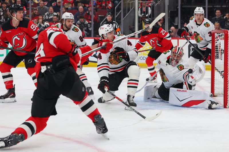 Mar 29, 2026; Newark, New Jersey, USA; Chicago Blackhawks goaltender Spencer Knight (30) makes a save on New Jersey Devils right wing Timo Meier (28) during the second period at Prudential Center. Mandatory Credit: Ed Mulholland-Imagn Images