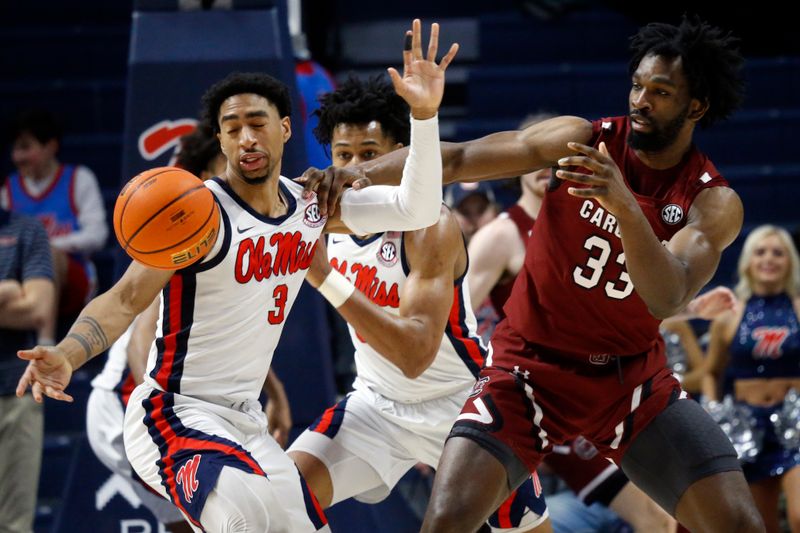 Feb 11, 2023; Oxford, Mississippi, USA; Mississippi Rebels forward Myles Burns (3) knock the ball away from South Carolina Gamecocks forward Josh Gray (33) during the second half at The Sandy and John Black Pavilion at Ole Miss. Mandatory Credit: Petre Thomas-USA TODAY Sports