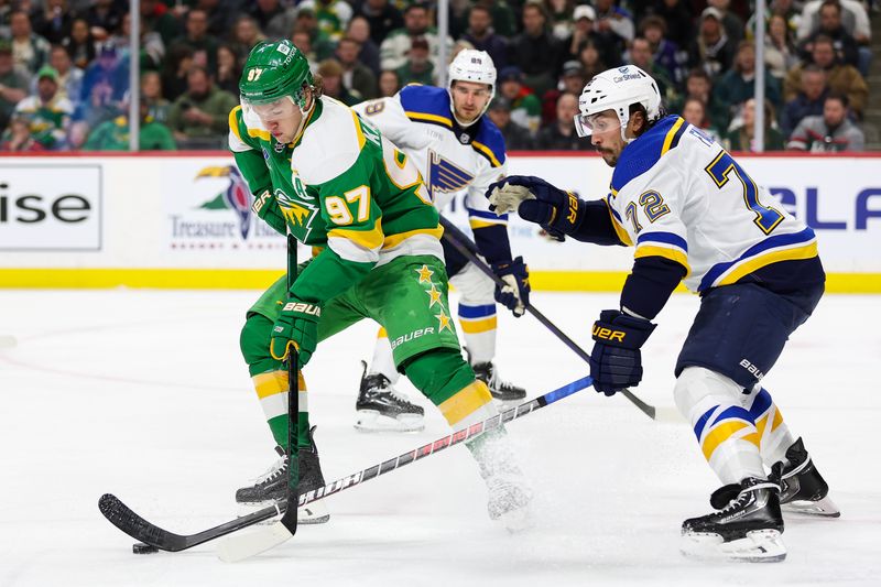 Mar 23, 2024; Saint Paul, Minnesota, USA; Minnesota Wild left wing Kirill Kaprizov (97) and St. Louis Blues defenseman Justin Faulk (72) compete for the puck during the third period at Xcel Energy Center. Mandatory Credit: Matt Krohn-USA TODAY Sports