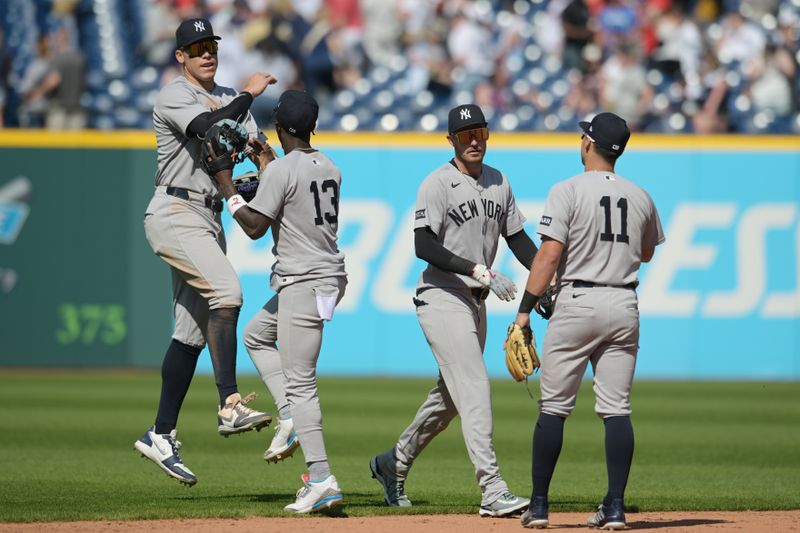 Apr 23, 2025; Cleveland, Ohio, USA; New York Yankees right fielder Aaron Judge (99) and second baseman Jazz Chisholm Jr. (13) and center fielder Cody Bellinger (35) and shortstop Anthony Volpe (11) celebrate after the Yankees beat the Cleveland Guardians at Progressive Field. Mandatory Credit: Ken Blaze-Imagn Images