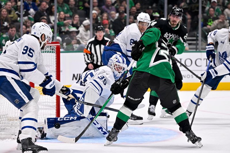 Dec 21, 2025; Dallas, Texas, USA; Toronto Maple Leafs goaltender Dennis Hildeby (35) stops a shot by Dallas Stars center Mavrik Bourque (22) during the second period at the American Airlines Center. Mandatory Credit: Jerome Miron-Imagn Images