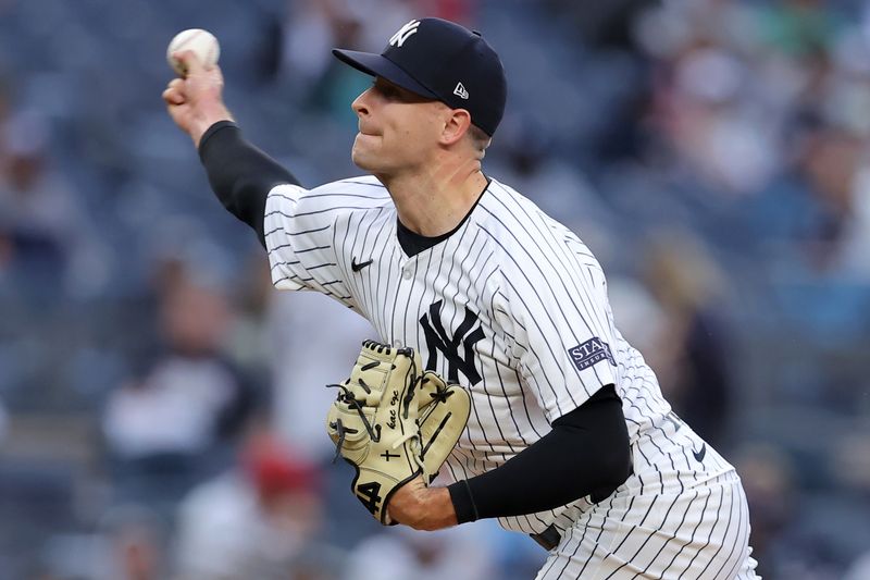 Aug 7, 2024; Bronx, New York, USA; New York Yankees relief pitcher Jake Cousins (61) pitches against the Los Angeles Angels during the seventh inning at Yankee Stadium. Mandatory Credit: Brad Penner-USA TODAY Sports