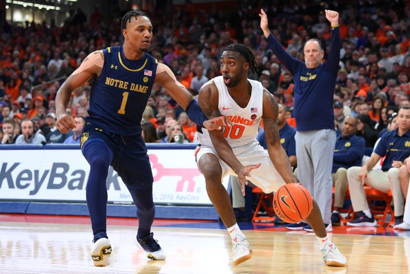 Jan 14, 2023; Syracuse, New York, USA; Syracuse Orange guard Symir Torrence (10) drives to the basket as Notre Dame Fighting Irish guard J.J. Starling (1) defends during the first half at the JMA Wireless Dome. Mandatory Credit: Rich Barnes-USA TODAY Sports