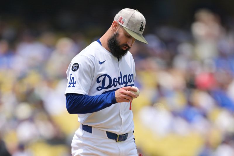 May 18, 2025; Los Angeles, California, USA; Los Angeles Dodgers pitcher Tony Gonsolin (26) reacts after Los Angeles Angels outfielder Taylor Ward (3) hits a two home run in the first inning at Dodger Stadium. Mandatory Credit: Jayne Kamin-Oncea-Imagn Images