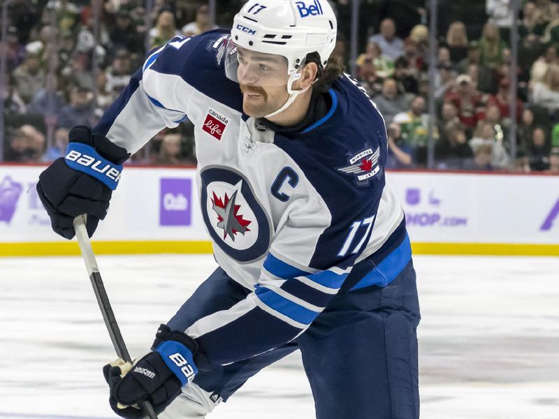 Nov 25, 2024; Saint Paul, Minnesota, USA;  Winnipeg Jets forward Adam Lowry (17) takes a shot on goal against the Minnesota Wild during the third period at Xcel Energy Center. Mandatory Credit: Nick Wosika-Imagn Images