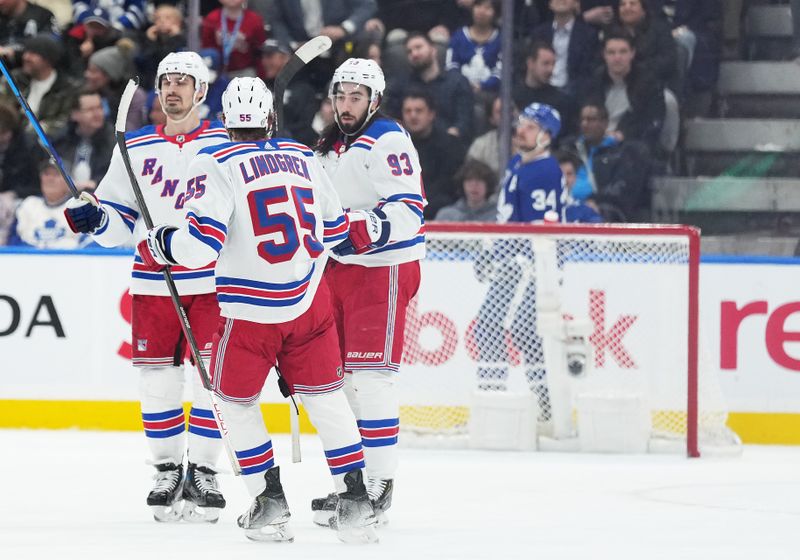 Dec 19, 2023; Toronto, Ontario, CAN; New York Rangers center Mika Zibanejad (93) scores an empty net goal and celebrates with  defenseman Ryan Lindgren (55) against the Toronto Maple Leafs during the third period at Scotiabank Arena. Mandatory Credit: Nick Turchiaro-USA TODAY Sports