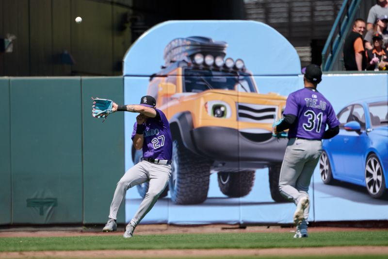 May 4, 2025; San Francisco, California, USA; Colorado Rockies outfielder Jordan Beck (27) loses a fly ball in the sun as second baseman Alan Trejo (31) looks on against the San Francisco Giants during the seventh inning at Oracle Park. Mandatory Credit: Robert Edwards-Imagn Images