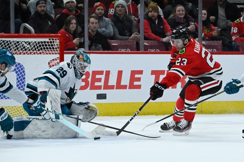 Jan 16, 2024; Chicago, Illinois, USA; Chicago Blackhawks center Philipp Kurashev (23) shoots against San Jose Sharks goaltender Mackenzie Blackwood (29) during the first period at United Center. Mandatory Credit: Matt Marton-USA TODAY Sports