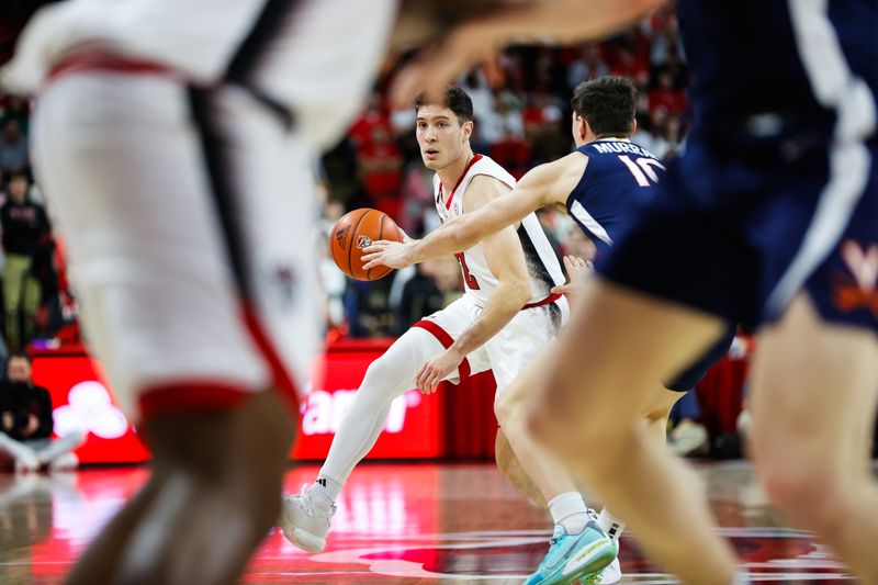 Jan 6, 2024; Raleigh, North Carolina, USA;  North Carolina State Wolfpack guard Michael O'Connell (12) looks on with the ball during the first half against Virginia Cavaliers at PNC Arena. Mandatory Credit: Jaylynn Nash-USA TODAY Sports
