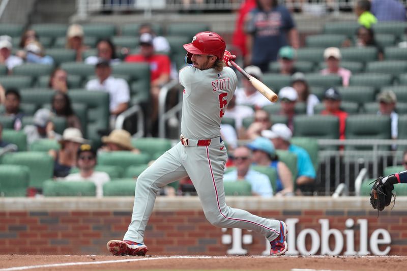 Jun 29, 2025; Cumberland, Georgia, Philadelphia Phillies second baseman Bryson Stott (5) hits a single during a game against the Atlanta Braves during the fifth inning at Truist Park. Mandatory Credit: Mady Mertens-Imagn Images