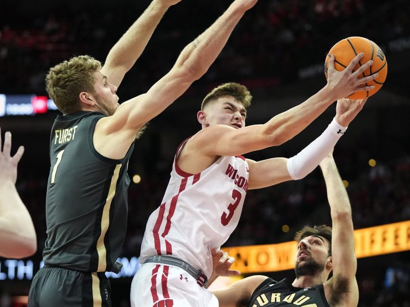 Mar 2, 2023; Madison, Wisconsin, USA; Wisconsin Badgers guard Connor Essegian (3) shoots the ball under coverage by Purdue Boilermakers forward Caleb Furst (1) and guard Ethan Morton (25) during the second half at the Kohl Center. Mandatory Credit: Kayla Wolf-USA TODAY Sports