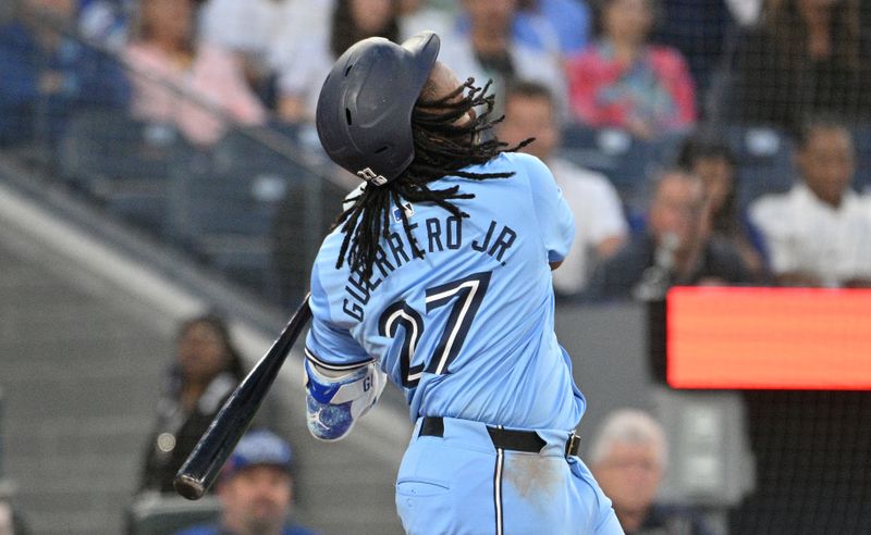 Jun 14, 2024; Toronto, Ontario, CAN;  Toronto Blue Jays first baseman Vladimir Guerrero Jr. (27) strikes out swinging against the Cleveland Guardians in the sixth inning at Rogers Centre. Mandatory Credit: Dan Hamilton-USA TODAY Sports