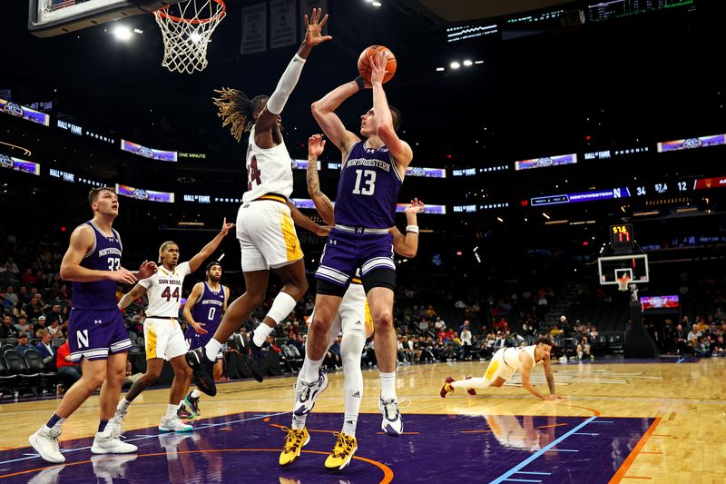 Dec 20, 2023; Phoenix, Arizona, USA; Northwestern Wildcats guard Brooks Barnhizer (13) shoots the ball against Arizona State Sun Devils forward Bryant Selebangue (24) during the first half during the Hall of Series at Footprint Center. Mandatory Credit: Mark J. Rebilas-USA TODAY Sports