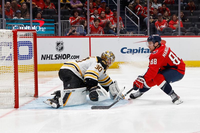 Oct 5, 2024; Washington, District of Columbia, USA; Boston Bruins goaltender Brandon Bussi (30) makes a save on Washington Capitals left wing Andrew Mangiapane (88) in the third period at Capital One Arena. Mandatory Credit: Geoff Burke-Imagn Images