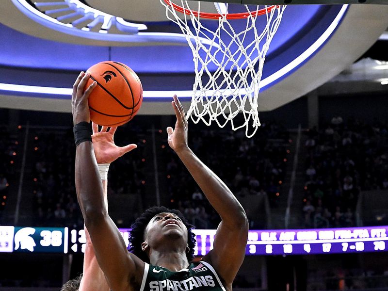 Jan 8, 2026; East Lansing, Michigan, USA;  aMichigan State Spartans forward Cameron Ward (3) makes a shot off the glass in spite of Northwestern Wildcats forward Nick Martinelli (2) during the second half at Jack Breslin Student Events Center. Mandatory Credit: Dale Young-Imagn Images
