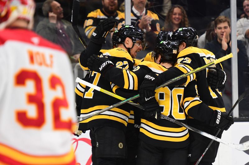 Nov 7, 2024; Boston, Massachusetts, USA;  Boston Bruins defenseman Hampus Lindholm (27) celebrates his goal with his line-mates during the first period against the Calgary Flames at TD Garden. Mandatory Credit: Bob DeChiara-Imagn Images