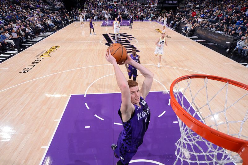 SACRAMENTO, CA - DECEMBER 8: Kevin Huerter #9 of the Sacramento Kings dunks the ball during the game against the Utah Jazz on December 8, 2024 at Golden 1 Center in Sacramento, California. NOTE TO USER: User expressly acknowledges and agrees that, by downloading and or using this Photograph, user is consenting to the terms and conditions of the Getty Images License Agreement. Mandatory Copyright Notice: Copyright 2024 NBAE (Photo by Rocky Widner/NBAE via Getty Images)