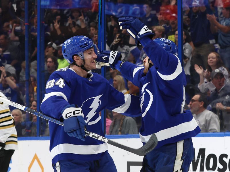 Nov 20, 2023; Tampa, Florida, USA; Tampa Bay Lightning left wing Tanner Jeannot (84) is congratulated by center Tyler Motte (64) after he scored a goal against the Boston Bruins during the first period at Amalie Arena. Mandatory Credit: Kim Klement Neitzel-USA TODAY Sports