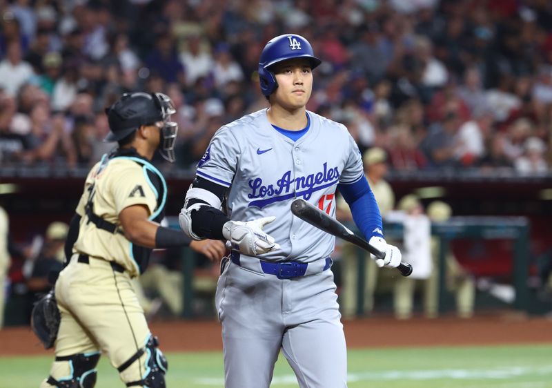 Apr 30, 2024; Phoenix, Arizona, USA; Los Angeles Dodgers designated hitter Shohei Ohtani reacts after striking out in the fourth inning against the Arizona Diamondbacks at Chase Field. Mandatory Credit: Mark J. Rebilas-USA TODAY Sports