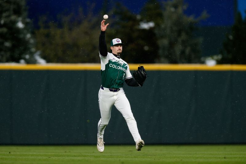 Apr 20, 2024; Denver, Colorado, USA; Colorado Rockies center fielder Brenton Doyle (9) throws the ball after a fielding play in the fourth inning against the Seattle Mariners at Coors Field. Mandatory Credit: Isaiah J. Downing-USA TODAY Sports