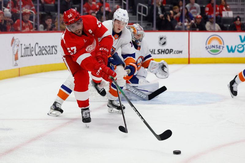 Feb 29, 2024; Detroit, Michigan, USA;  Detroit Red Wings left wing David Perron (57) skates with the puck chased by New York Islanders right wing Simon Holmstrom (10) in the second period at Little Caesars Arena. Mandatory Credit: Rick Osentoski-USA TODAY Sports