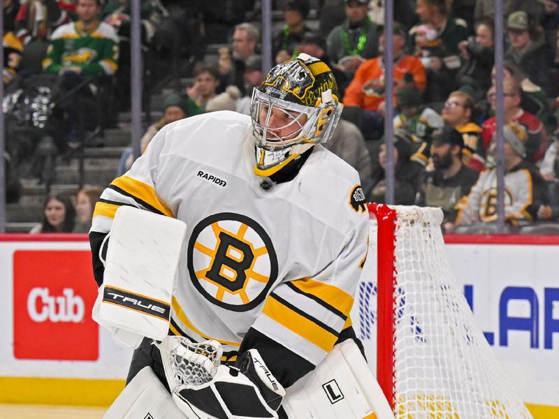 Dec 14, 2025; Saint Paul, Minnesota, USA; Boston Bruins goalie Jeremy Swayman (1) controls the puck against the Minnesota Wild during the second period at Grand Casino Arena. Mandatory Credit: Nick Wosika-Imagn Images