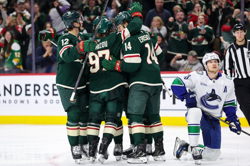 Dec 3, 2024; Saint Paul, Minnesota, USA; Minnesota Wild defenseman Jake Middleton (5) celebrates his goal with teammates during the third period against the Vancouver Canucks at Xcel Energy Center. Mandatory Credit: Matt Krohn-Imagn Images