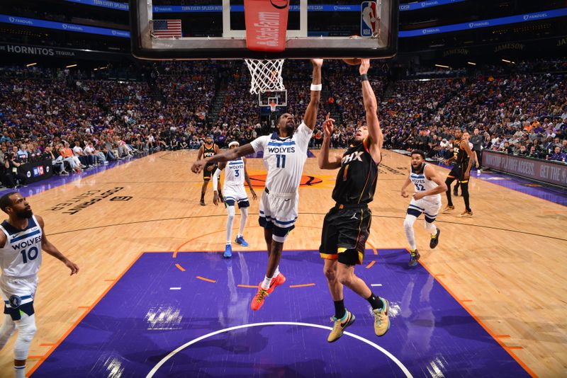 PHOENIX, AZ - APRIL 4: Devin Booker #1 of the Phoenix Suns shoots the ball while Naz Reid #11 of the Minnesota Timberwolves goes up for the block during the game during Round 1 Game 4 of the 2024 NBA Playoffs on April 4, 2023 at Footprint Center in Phoenix, Arizona. NOTE TO USER: User expressly acknowledges and agrees that, by downloading and or using this photograph, user is consenting to the terms and conditions of the Getty Images License Agreement. Mandatory Copyright Notice: Copyright 2024 NBAE (Photo by Barry Gossage/NBAE via Getty Images)