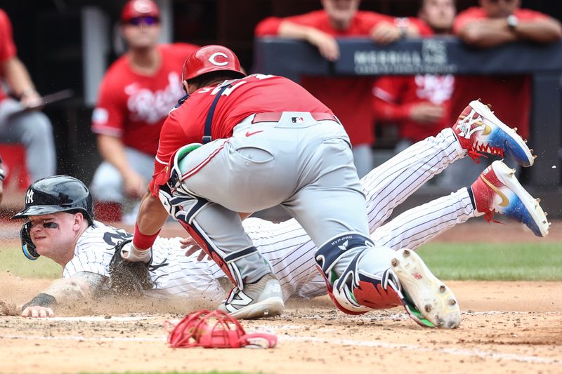 Jul 4, 2024; Bronx, New York, USA; New York Yankees left fielder Alex Verdugo (24) is tagged out at home plate by Cincinnati Reds catcher Luke Maile (22) in the sixth inning at Yankee Stadium. Mandatory Credit: Wendell Cruz-USA TODAY Sports