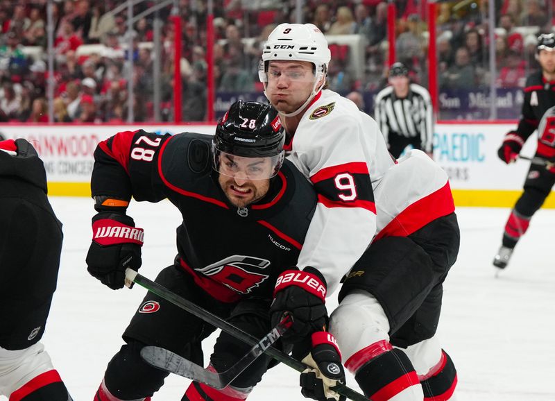 Nov 16, 2024; Raleigh, North Carolina, USA;  Carolina Hurricanes left wing William Carrier (28) and Ottawa Senators center Josh Norris (9) battle for position during the first period at Lenovo Center. Mandatory Credit: James Guillory-Imagn Images