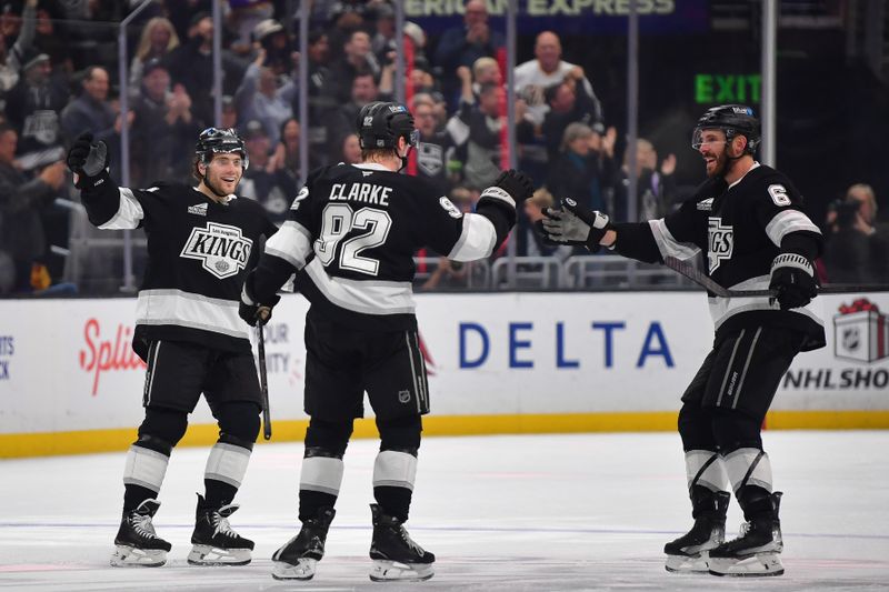 Nov 24, 2025; Los Angeles, California, USA; Los Angeles Kings defenseman Brandt Clarke (92) celebrates his power play goal scored against the Ottawa Senators with right wing Alex Laferriere (14) and defenseman Joel Edmundson (6) during the third period at Crypto.com Arena. Mandatory Credit: Gary A. Vasquez-Imagn Images